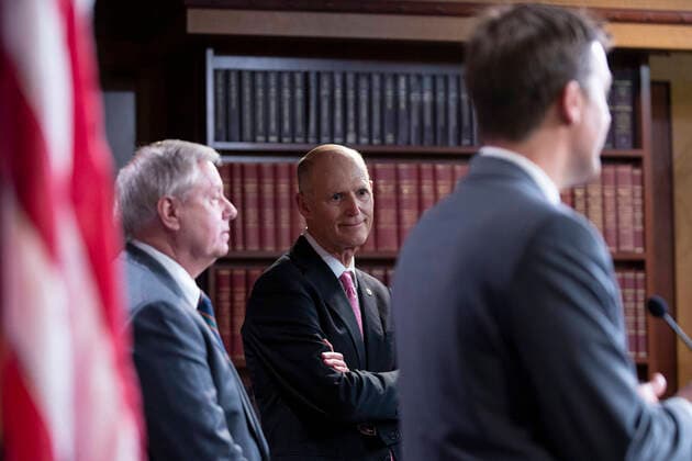 March 25, 2020, Washington, District of Columbia, USA: United States Senator Rick Scott (Republican of Florida) listens during a news conference with United States Senator Lindsey Graham (Republican of South Carolina) and United States Senator Ben Sasse (Republican of Nebraska) at the United States Capitol in Washington D.C., U.S. on Wednesday, March 25, 2020. The Senators are calling for a correction to a supposed drafting error in the Coronavirus Stimulus Package that the Senate was set to vote on today, stating it incentivizes unemployment. Ã‚ Credit: CNP Washington USA - ZUMAs152 20200325_zaa_s152_075 Copyright: xStefanixReynoldsx