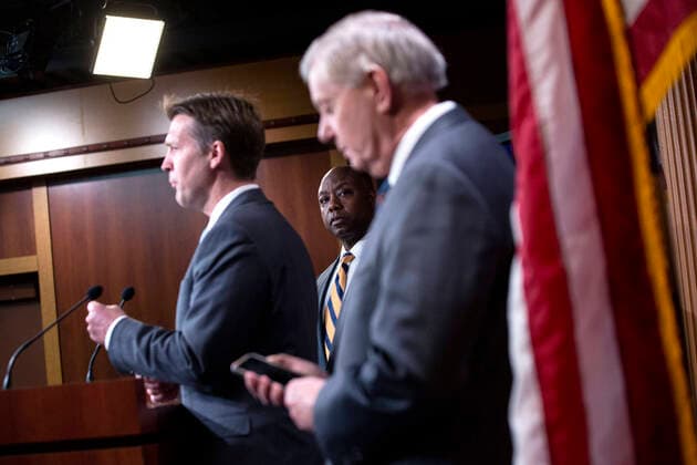 March 25, 2020, Washington, District of Columbia, USA: United States Senator Lindsey Graham (Republican of South Carolina) and United States Senator Tim Scott (Republican of South Carolina) listen as United States Senator Ben Sasse (Republican of Nebraska) speaks during a news conference at the United States Capitol in Washington D.C., U.S. on Wednesday, March 25, 2020. The Senators are calling for a correction to a supposed drafting error in the Coronavirus Stimulus Package that the Senate was set to vote on today, stating it incentivizes unemployment. Ã‚ Credit: CNP Washington USA - ZUMAs152 20200325_zaa_s152_077 Copyright: xStefanixReynoldsx