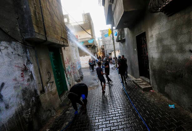 March 25, 2020, Gaza City, The Gaza Strip, Palestine: A Palestinian sprays disinfectant as a precaution against the spread of the Covid-19 coronavirus, in the streets of the Jabalia refugee camp, northern Gaza Strip, 25 March 2020. The Palestinian Ministry of Health in Gaza had confirmed on 22 March 2020 that there were two cases of novel coronavirus Covid-19 in the Gaza Strip. Gaza City Palestine - ZUMAq100 20200325_zaa_q100_044 Copyright: xMahmoudxIssax