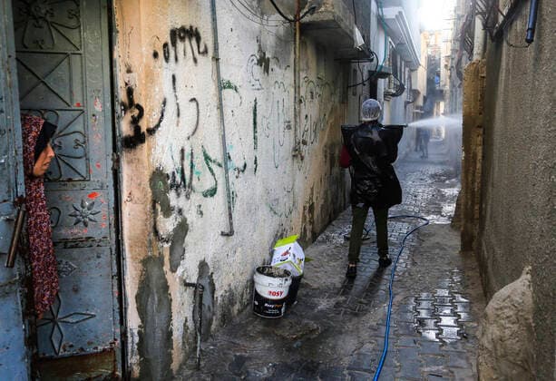 March 25, 2020, Gaza City, The Gaza Strip, Palestine: A Palestinian sprays disinfectant as a precaution against the spread of the Covid-19 coronavirus, in the streets of the Jabalia refugee camp, northern Gaza Strip, 25 March 2020. The Palestinian Ministry of Health in Gaza had confirmed on 22 March 2020 that there were two cases of novel coronavirus Covid-19 in the Gaza Strip. Gaza City Palestine - ZUMAq100 20200325_zaa_q100_045 Copyright: xMahmoudxIssax