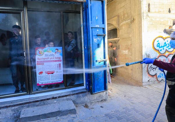 March 25, 2020, Gaza City, The Gaza Strip, Palestine: A Palestinian sprays disinfectant as a precaution against the spread of the Covid-19 coronavirus, in the streets of the Jabalia refugee camp, northern Gaza Strip, 25 March 2020. The Palestinian Ministry of Health in Gaza had confirmed on 22 March 2020 that there were two cases of novel coronavirus Covid-19 in the Gaza Strip. Gaza City Palestine - ZUMAq100 20200325_zaa_q100_049 Copyright: xMahmoudxIssax