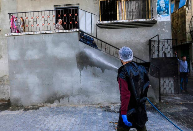 March 25, 2020, Gaza City, The Gaza Strip, Palestine: A Palestinian sprays disinfectant as a precaution against the spread of the Covid-19 coronavirus, in the streets of the Jabalia refugee camp, northern Gaza Strip, 25 March 2020. The Palestinian Ministry of Health in Gaza had confirmed on 22 March 2020 that there were two cases of novel coronavirus Covid-19 in the Gaza Strip. Gaza City Palestine - ZUMAq100 20200325_zaa_q100_065 Copyright: xMahmoudxIssax