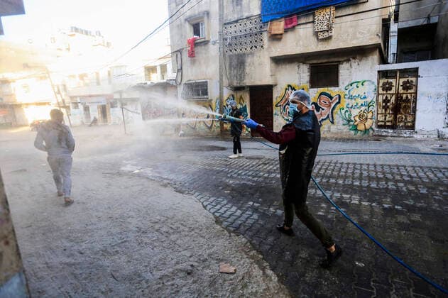 March 25, 2020, Gaza City, The Gaza Strip, Palestine: A Palestinian sprays disinfectant as a precaution against the spread of the Covid-19 coronavirus, in the streets of the Jabalia refugee camp, northern Gaza Strip, 25 March 2020. The Palestinian Ministry of Health in Gaza had confirmed on 22 March 2020 that there were two cases of novel coronavirus Covid-19 in the Gaza Strip. Gaza City Palestine - ZUMAq100 20200325_zaa_q100_069 Copyright: xMahmoudxIssax