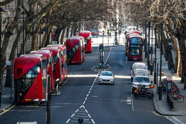 A general view of London Red Buses gathering from the Golden Jubilee Bridge looking towards nearly empty Trafalgar Square, Wednesday, March 25, 2020. British lawmakers voted to shut down Parliament for 4 weeks, due to the coronavirus outbreak. The new coronavirus causes mild or moderate symptoms for most people, but for some, especially older adults and people with existing health problems, it can cause more severe illness or death. (Photo Vudi Xhymshiti)  iMagoVX