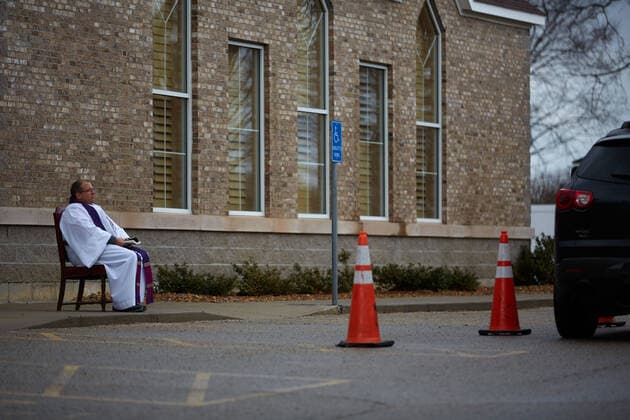 March 25, 2020, Uxbridge, Massachusetts, US: Due to COVID-19, Corona Virus, St. Mary s Church in Uxbridge, Masachusetts is holding drive up confession. The car drives up, and the seated Priest will listen and prescribe a penance and give absolution. Uxbridge US - ZUMAd211 20200325_zap_d211_003 Copyright: xAllisonxDinnerx