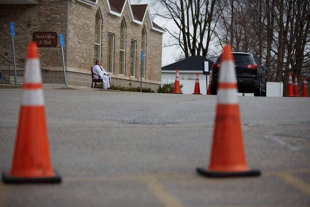 March 25, 2020, Uxbridge, Massachusetts, US: Due to COVID-19, Corona Virus, St. Mary s Church in Uxbridge, Masachusetts is holding drive up confession. The car drives up, and the seated Priest will listen and prescribe a penance and give absolution. Uxbridge US - ZUMAd211 20200325_zap_d211_006 Copyright: xAllisonxDinnerx