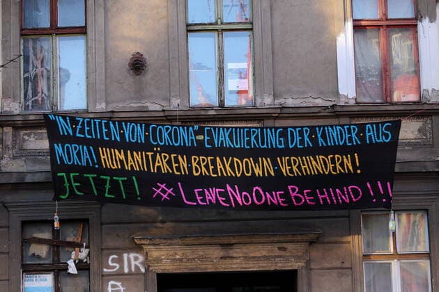 A banner with the inscription In Times Of Corona Evacuation Of Children From Moria Humanitarian Breakdown Prevent Now Leave No One Behind hangs on a house in Potsdam, 25 March 2020 Protest Refugee Policy Potsdam