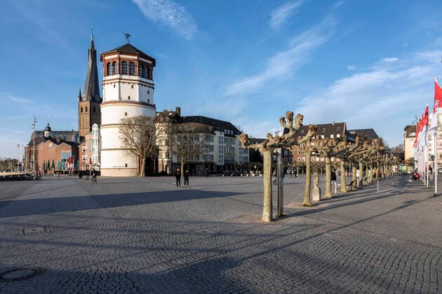 Old town Düsseldorf, the Burgplatz as a central square on the Rhine with castle tower, unusually almost deserted