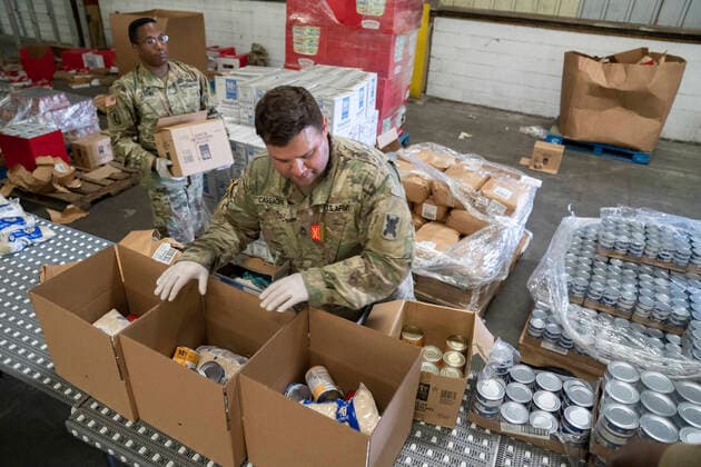 March 26, 2020, New Orleans, LA, United States: Louisiana National Guard soldiers box canned goods to be distributed throughout the New Orleans area Second Harvest Food Bank in support of COVID-19, coronavirus quarantine orders March 26, 2020 in New Orleans, Louisiana. New Orleans United States - ZUMAp138 20200326_zaa_p138_002 Copyright: xJosiahxPugh UsxArmyx