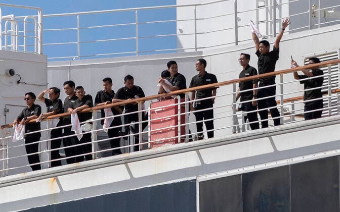 March 26, 2020, San Diego, California, USA: Crew members of the cruise ship ship Westerdam, already pierside in San Diego, cheered as the cruise ship Maasdam arrived in San Diego March 26, 2020. Maasdam was denied permission on March 20 to disembark passengers in Hawaii because of concerns about the COVID-19 virus. Hawaii did allow six residents, a woman with a broken leg and her spouse to leave the ship in Honolulu. Maasdam was allowed to dock in San Diego, and passengers will be allowed to leave in groups after testing confirms their infection status. San Diego USA - ZUMAb202 20200326_znp_b202_006 Copyright: xDavidxBarakx