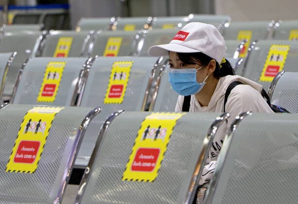 March 27, 2020, Bangkok, Thailand: Passenger looks on while sits next at chairs with stickers to keep social distancing to stop the spread of Coronavirus Covid-19 at bus terminal in Bangkok on March 27, 2020. Globally, the virus has now infected more than 532,670 people and killed at least 24,092. Bangkok Thailand - ZUMAu103 20200327_zia_u103_001 Copyright: xUrdeexImagex
