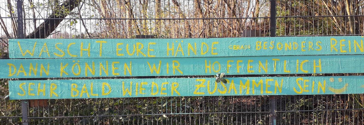 Coronavirus crisis hint and wish at the fence at a construction playground in Hamburg