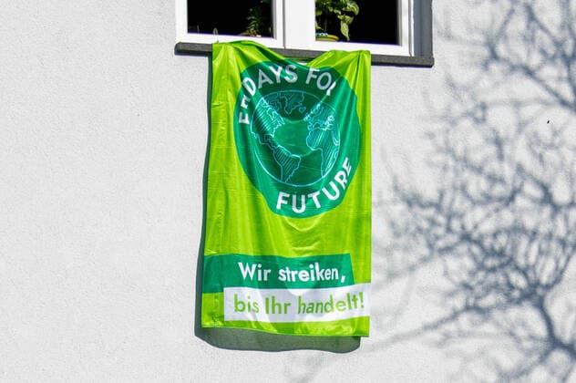 Transparent, flag of the environmental movement Fridays For Future with the inscription We strike until you act on a house wall in Solingen Topic picture, symbol picture, Fridays For Future, transparent, 27 03 20 Solingen NRW Germany Copyright: xdnet_cdnx