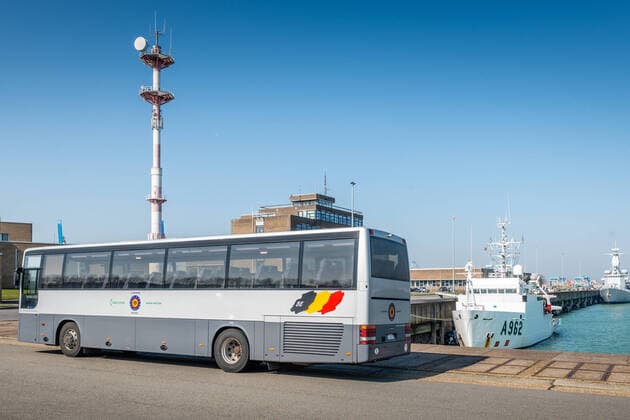 ATTENTION EDITORS - HAND OUT PICTURES - EDITORIAL USE ONLY - MANDATORY CREDIT A bus waits at the arrival of Belgian frigate Leopold 1 in Zeebrugge, Friday 27 March 2020. One of the sailors on the frigate has a confirmed Corona virus infection and has left the ship earlier. Due to the strict measures following such an infection, the ship has returned earlier from its mission and all non-infected sailors must now stay in home quarantine.  HANDOUTxDEFENSIEx-xDEFENCExTBNxJORNxURBAIN 05786917