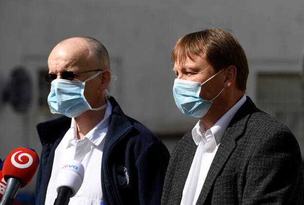Doctor Martin Balik, left, and director of the General Teaching Hospital in Prague David Feltl, right, speak during a press conference on coronavirus treatment, on March 27, 2020, in Prague, Czech Republic. The condition of a Czech COVID-19 patient has markedly improved after the U.S. remdesivir experimental medicine was administered to him for three days. (CTKxPhoto MichalxKrumphanzl) CTKPhotoP202003270470801 kru 1