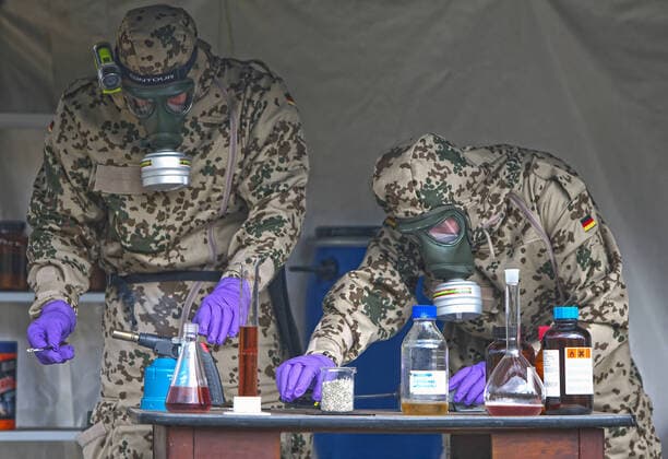 Bundeswehr soldiers of the NBC nuclear, biological, chemical defence force during an exercise The soldiers detect explosive ordnance, rescue persons and comrades under special protective clothing and decontaminate vehicles, areas and persons Soldiers of the NBC defence force during an exercise on the Bergen military training area on 25 09 2014 Bergen Lower Saxony Germany