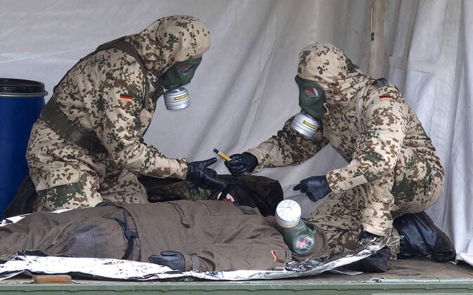 Bundeswehr soldiers of the NBC nuclear, biological, chemical defence force during an exercise The soldiers detect explosive ordnance, rescue persons and comrades under special protective clothing and decontaminate vehicles, areas and persons Soldiers of the NBC defence force during an exercise on the Bergen military training area on 25 09 2014 Bergen Lower Saxony Germany