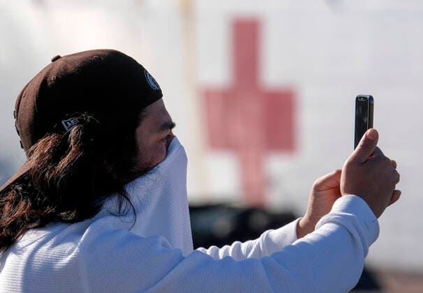 March 26, 2020, Los Angeles, California, U.S: A man takes pictures as the USNS Mercy Hospital Ship docks at the cruise ship terminal after arriving at the Port of Los Angeles on Friday, March 27, 2020. Mercy departed Naval Base San Diego Monday with more than 800 Navy medical personnel and support staff with the afloat medical treatment facility, and 70-plus civil service mariners who operate and navigate the ship, load and off-load mission cargo, assist with repairs to mission equipment and provide essential services to keep the medical facility up and running. Los Angeles U.S. - ZUMAc68_ 20200326_zaf_c68_033 Copyright: xRingoxChiux