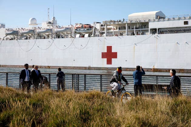 March 27, 2020, San Pedro, California, USA: People take pictures as others walk past the U.S. Navy hospital ship USNS Mercy as it docks at the Port of Los Angeles to provide relief to area hospitals impacted by the novel coronavirus on Friday, March 27, 2020 in San Pedro, California. The ship will offer 1,000 beds for treatment to non-infected patients in order to allow LA hospitals to focus on patients suffering from the virus and increase hospital capacity to treat COVID-19. Ã‚ 2020 Patrick T. Fallon San Pedro USA - ZUMAf72_ 20200327_zaf_f72_002 Copyright: xPatrickxFallonx