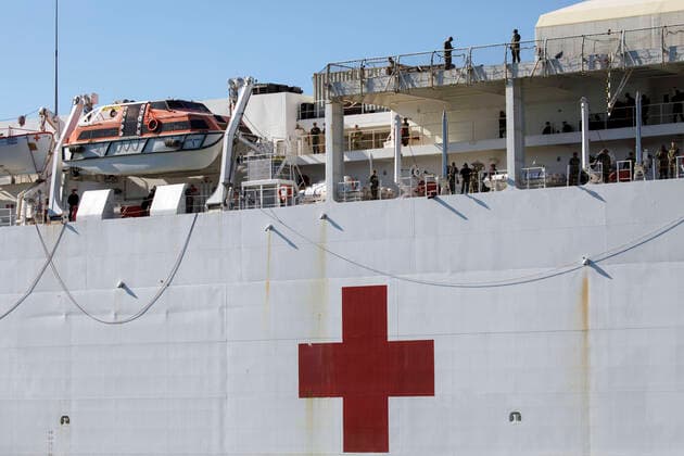 March 27, 2020, San Pedro, California, USA: Crew members look from decks as the U.S. Navy hospital ship USNS Mercy docks at the Port of Los Angeles to provide relief to area hospitals impacted by the novel coronavirus on Friday, March 27, 2020 in San Pedro, California. The ship will offer 1,000 beds for treatment to non-infected patients in order to allow LA hospitals to focus on patients suffering from the virus and increase hospital capacity to treat COVID-19. Ã‚ 2020 Patrick T. Fallon San Pedro USA - ZUMAf72_ 20200327_zaf_f72_015 Copyright: xPatrickxFallonx