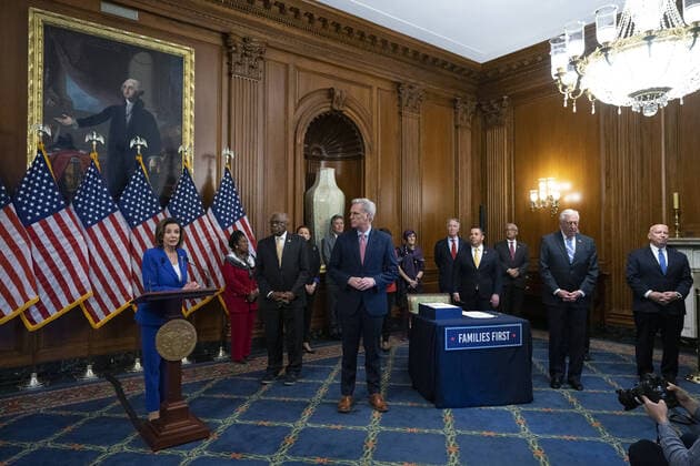 Lawmakers try to keep their distance as Speaker of the House Nancy Pelosi speaks during a signing ceremony after the House passed the $2.2 trillion CARES Act at the U.S. Capitol on Friday, March 27, 2020 in Washington, D.C. The stimulus bill, the largest in U.S history, provides economic bailouts to companies, independent contractors and includes direct payments to individuals as the U.S. suffers from the COVID-19 pandemic.  WAP202003278042 STEFANIxREYNOLDS