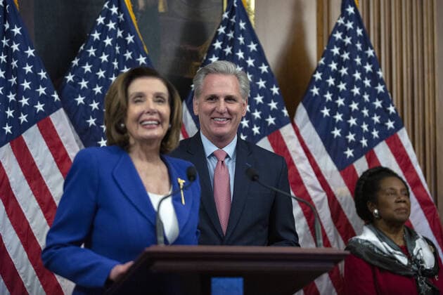 House Minority Leader Kevin McCarthy listens as Speaker of the House Nancy Pelosi speaks during a signing ceremony after the House passed the $2.2 trillion CARES Act at the U.S. Capitol on Friday, March 27, 2020 in Washington, D.C. The stimulus bill, the largest in U.S history, provides economic bailouts to companies, independent contractors and includes direct payments to individuals as the U.S. suffers from the COVID-19 pandemic.  WAP202003278030 STEFANIxREYNOLDS