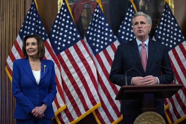 Speaker of the House Nancy Pelosi listens as House Minority Leader Kevin McCarthy speaks during a signing ceremony after the House passed the $2.2 trillion CARES Act at the U.S. Capitol on Friday, March 27, 2020 in Washington, D.C. The stimulus bill, the largest in U.S history, provides economic bailouts to companies, independent contractors and includes direct payments to individuals as the U.S. suffers from the COVID-19 pandemic.  WAP202003278032 STEFANIxREYNOLDS