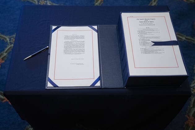 The $2.2 trillion CARES Act is seen on a table prior to the signing ceremony at the U.S. Capitol on Friday, March 27, 2020 in Washington, D.C. The stimulus bill, the largest in U.S history, provides economic bailouts to companies, independent contractors and includes direct payments to individuals as the U.S. suffers from the COVID-19 pandemic.  WAP202003278053 STEFANIxREYNOLDS