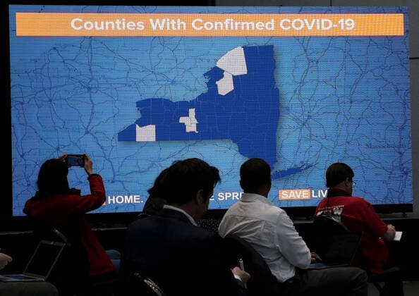 A monitor shows a map of New York Counties with confirmed COVIS-19 cases while Gov. Andrew Cuomo speaks with the New York National Guard on site at the Jacob K. Javits Convention Center in New York City on Friday, March 27, 2020. The Javits Center is setting up to be turned into field hospitals to test and possibly treat cases of COVID-19 infections. Almost half of the United States are under stay-at-home orders and the United States has become the country with the most confirmed coronavirus cases at over 94,000.  NYP20200327122 JOHNxANGELILLO