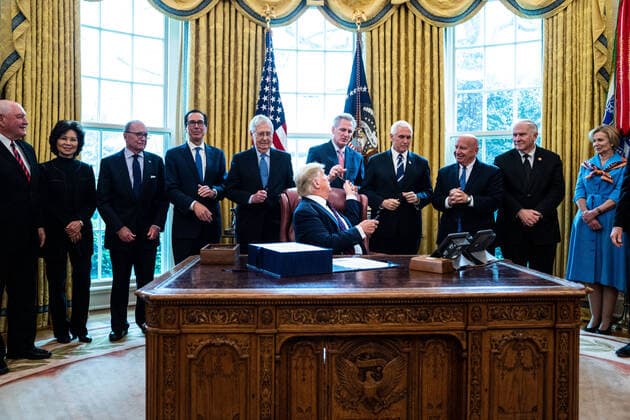 President Donald Trump participates in a signing ceremony for a two trillion dollar coronavirus relief bill in the Oval Office at the White House in Washington, DC on March 27, 2020. The economic stimulus package, the largest in U.S. history, provides economic bailouts to companies, independent contractors and includes direct payments to individuals as the U.S. suffers from the COVID-19 pandemic.  WAX20200327403 ERINxSCHAFF