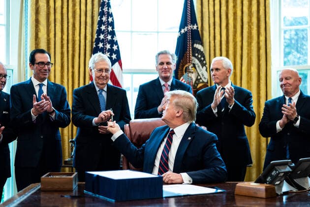 United States President Donald J. Trump hands a pen to United States Senate Majority Leader Mitch McConnell (Republican of Kentucky) after signing ceremony the two trillion dollar coronavirus relief bill in the Oval Office at the White House in Washington, DC on March 27, 2020. Pictured behind the President, from left to right: Director of the National Economic Council Larry Kudlow; US Secretary of the Treasury Steven T. Mnuchin; Leader McConnell; US House Minority Leader Kevin McCarthy (Republican of California); US Vice President Mike Pence; and US Representative Kevin Brady (Republican of Texas). Copyright: xErinxSchaffx