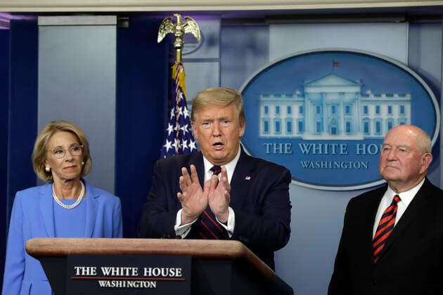 March 27, 2020, Washington, District of Columbia, USA: United States President Donald J. Trump speaks between US Secretary of Education Betsy DeVos, left, and US Secretary of Agriculture Sonny Perdue and Agriculture Secretary Sonny Perdue during a press briefing on the Coronavirus COVID-19 pandemic with members of the Coronavirus Task Force at the White House in Washington, DC on March 27, 2020. .Credit: Pool via CNP Washington USA - ZUMAs152 20200327_zaa_s152_065 Copyright: xYurixGripasx