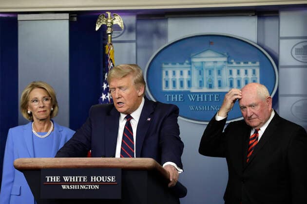March 27, 2020, Washington, District of Columbia, USA: United States President Donald J. Trump speaks between US Secretary of Education Betsy DeVos, left, and US Secretary of Agriculture Sonny Perdue and Agriculture Secretary Sonny Perdue during a press briefing on the Coronavirus COVID-19 pandemic with members of the Coronavirus Task Force at the White House in Washington, DC on March 27, 2020. .Credit: Pool via CNP Washington USA - ZUMAs152 20200327_zaa_s152_068 Copyright: xYurixGripasx