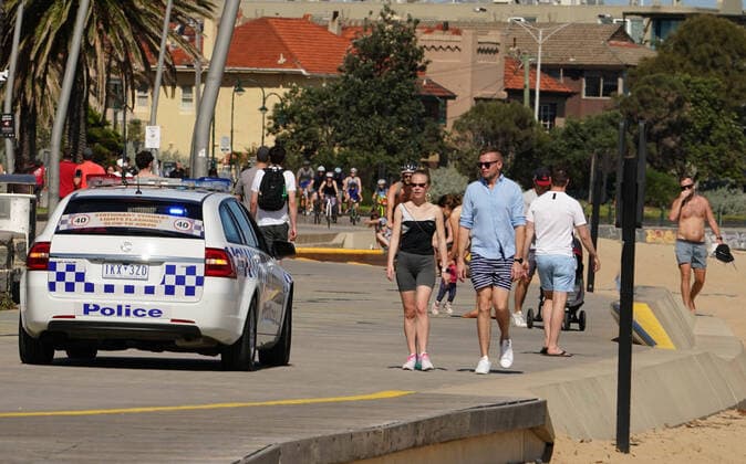 AUSTRALIA CORONAVIRUS COVID-19, A Police car patrols St Kilda Beach in Melbourne, Saturday, March 28, 2020. Port Phillip City Council has clamped down on large groups accessing all of its beaches including the popular St Kilda Beach. A shutdown of non-essential services is in effect Australia wide in a bid to slow the spread of the coronavirus (COVID-19) disease. ( NO ARCHIVING, EDITORIAL USE ONLY, NO USE IN BOOKS WITHOUT CONSENT MELBOURNE VIC AUSTRALIA  Copyright: xSCOTTxBARBOURx 20200328001460557087