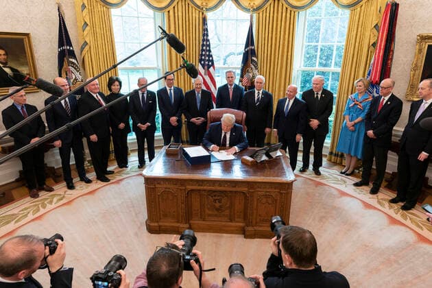March 27, 2020, Washington, The District of Columbia, United States Of America: President Donald J. Trump, joined by Vice President Mike Pence, White House Coronavirus Task Force members, Cabinet members, Republican Senate leadership, and White House senior staff members, poses for a photo before signing the Ã’Coronavirus Aid, Relief, and Economic Security (CARES) Act,O a $2.2 trillion emergency assistance bill in response to the coronavirus pandemic Friday, March 27, 2020, in the Oval Office of the White House..People: President Donald J. Trump. Washington United States Of America - ZUMAs214 20200327_zaa_s214_005 Copyright: xSMGx