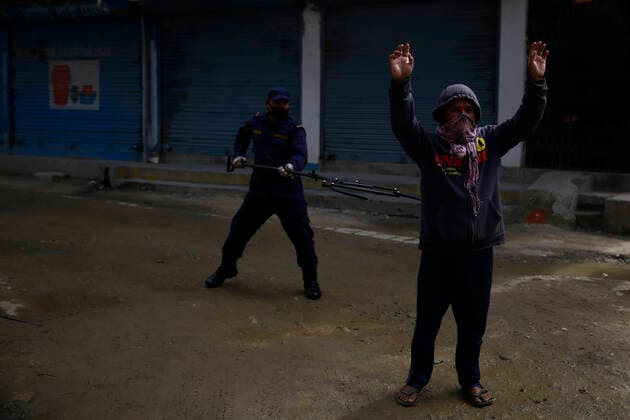 March 28, 2020, Kathmandu, Nepal: A policeman arresting a lockdown violator using a multifunctional device that lets him maintain social distance on the fifth day of government imposed nationwide lockdown amid concerns over the coronavirus pandemic in Kathmandu, Nepal on Saturday, March 28, 2020. Kathmandu Nepal - ZUMAg200 20200328_zap_g200_001 Copyright: xSkandaxGautamx