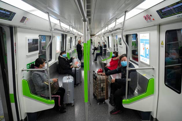 (200328) -- WUHAN, March 28, 2020 -- Passengers sit apart on a train of Metro Line 4 in Wuhan, central China s Hubei Province, March 28, 2020. Six metro lines in Wuhan resumed operation starting from Saturday, a new sign that life is gradually returning to normal in the hardest-hit city. Passengers are required to scan the QR code for real-name registration and take temperature checks before taking the subway. Each train is equipped with a train safety crew member to help guide and serve the passengers. ) CHINA-HUBEI-WUHAN-METRO-OPERATION RESTORATION (CN) CaixYang 