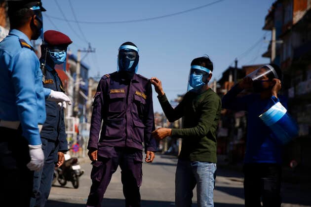 March 28, 2020, Kathmandu, Nepal: Police personnel try on face shields without charge given by the local people of Dillibazar on the fifth day of government imposed lockdown amid concerns over coronavirus pandemic in Kathmandu, Nepal on Saturday, March 28, 2020. Kathmandu Nepal - ZUMAg200 20200328_zap_g200_015 Copyright: xSkandaxGautamx