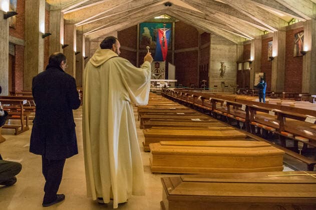 Seriate. Bergamo. Blessing of 90 bodies by Don Marcello Crotti parish priest of the church of San Giuseppe in Seriate waiting place before cremation of people who died as a result of COVID19 Coronavirus (Carlo Cozzoli Fotogramma, Seriate - 2020-03-28) p.s. la foto e utilizzabile nel rispetto del contesto in cui e stata scattata, e senza intento diffamatorio del decoro delle persone rappresentate  Copyright: xCarloxCozzolix xFOTOGRAMMAx