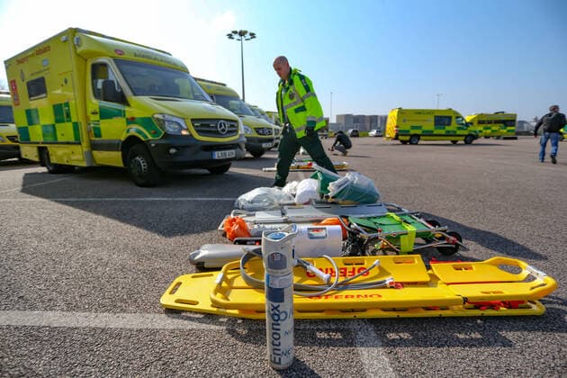 BRITAIN VIRUS OUTBREAK - NHS Support Unit personnel is seen setting up medical support hardware equipment at the ExCel Centre in London on Saturday, March 28, 2020. NHS Nightingale makeshift hospital is being made into a temporary 4000-bed, comprising of two wards, each of 2,000 people, to help tackle the coronavirus outbreak in Britain. (Photo Vudi Xhymshiti)  iMagoVX