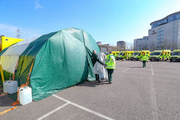 BRITAIN VIRUS OUTBREAK - NHS Support Unit personnel is seen setting up medical support hardware equipment at the ExCel Centre in London on Saturday, March 28, 2020. NHS Nightingale makeshift hospital is being made into a temporary 4000-bed, comprising of two wards, each of 2,000 people, to help tackle the coronavirus outbreak in Britain. (Photo Vudi Xhymshiti)  iMagoVX