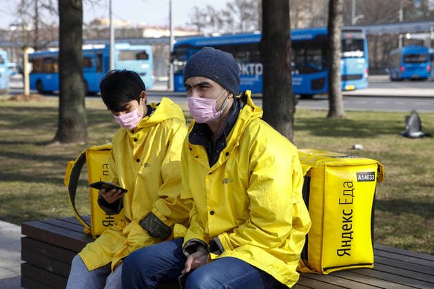 MOSCOW, RUSSIA - MARCH 28, 2020: Yandex Food couriers wear face masks amid the ongoing COVID-19 pandemic. Artyom Geodakyan TASS  TS0D3B4F