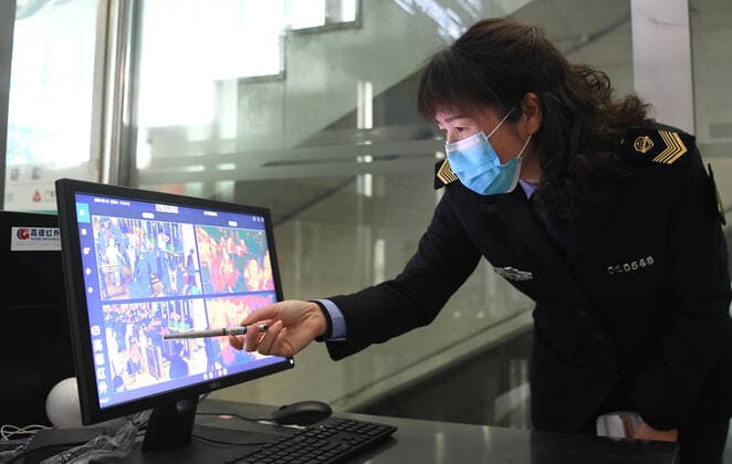 (200328) -- WUHAN, March 28, 2020 -- A staff monitors a computer screen showing temperatures of passengers at Wuhan Railway Station in Wuhan, central China s Hubei Province, March 28, 2020. Inbound trains started arriving in Wuhan s 17 train stations on Saturday. ) CHINA-WUHAN-RAILWAY-INBOUND SERVICE-RESUMPTION (CN) ChengxMin 