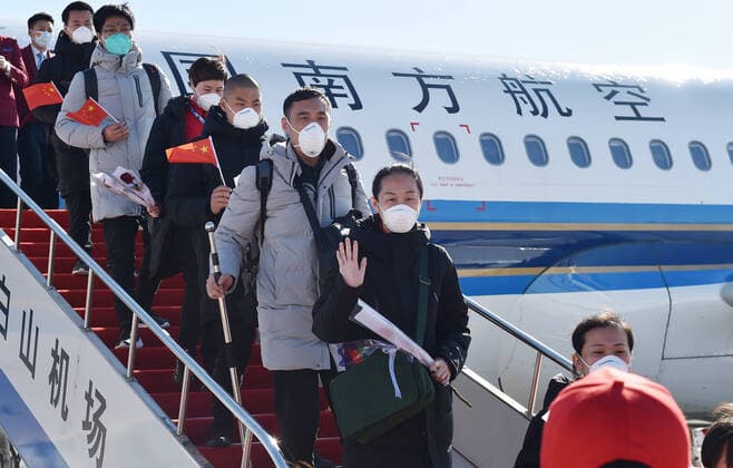 (200328) -- CHANGBAISHAN, March 28, 2020 -- Medical workers supporting virus-hit Hubei Province disembark from a chartered plane at Changbaishan Airport in northeast China s Jilin Province, March 28, 2020. The third batch of medical assistance teams from Jilin, which consists of 404 members, returned from Hubei as the epidemic outbreak in the hard-hit province has been subdued. ) CHINA-JILIN-MEDICAL TEAM-RETURN FROM HUBEI (CN) LinxHong 