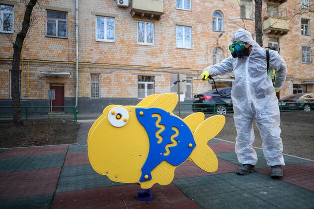 MOSCOW, RUSSIA - MARCH 28, 2020: A sanitary worker in a protective suit disinfects a children s playground in a residential area of Moscow. Since 5 March, Moscow has been on high alert in connection with the pandemic of the novel coronavirus (COVID-19). Streets and other public areas are cleaned and disinfected to counter the spread of the novel coronavirus. As of 28 March 2020, Russia has reported more than 1200 confirmed cases of the novel coronavirus (COVID-19), with more than 800 confirmed cases in Moscow. Sergei Bobylev TASS  TS0D3B20