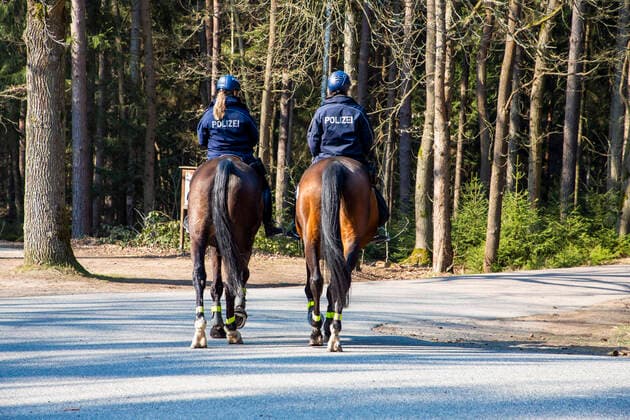 Policewomen of the police riding team Großerkmannsdorf control the observance of the limited curfew in connection with the fight against the coronavirus in the Tharandter Wald near Grillenburg