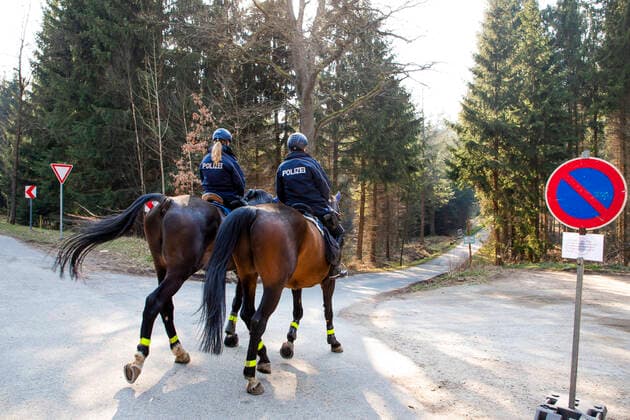 Policewomen of the police riding team Großerkmannsdorf control the observance of the limited curfew in connection with the fight against the coronavirus in the Tharandter Wald near Grillenburg
