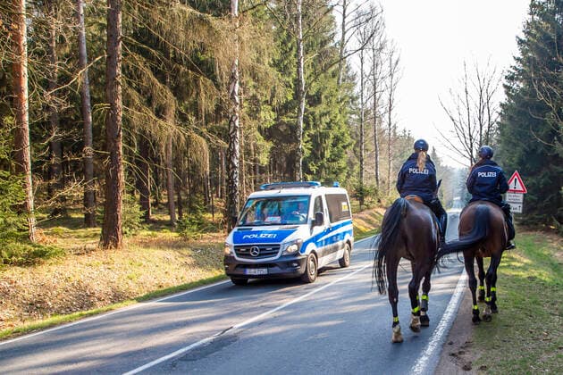 Policewomen of the police riding team Großerkmannsdorf control the observance of the limited curfew in connection with the fight against the coronavirus in the Tharandter Wald near Grillenburg