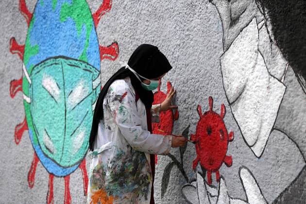 March 28, 2020, Khan Younis, Gaza Strip, Palestinian Territory: Palestinian artists draw a mural during awareness campaign about the coronavirus COVID-19, in Khan Younis in the southern of Gaza Strip on March 28, 2020 Khan Younis Palestinian Territory - ZUMAap3_ 20200328_zaf_ap3_001 Copyright: xAshrafxAmrax