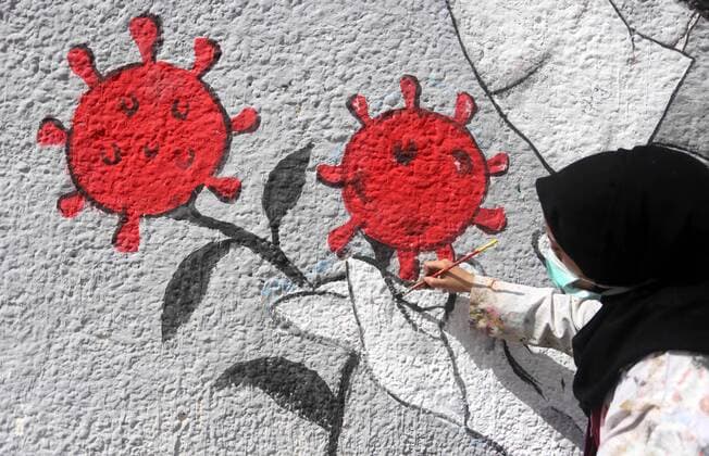 March 28, 2020, Khan Younis, Gaza Strip, Palestinian Territory: Palestinian artists draw a mural during awareness campaign about the coronavirus COVID-19, in Khan Younis in the southern of Gaza Strip on March 28, 2020 Khan Younis Palestinian Territory - ZUMAap3_ 20200328_zaf_ap3_002 Copyright: xAshrafxAmrax